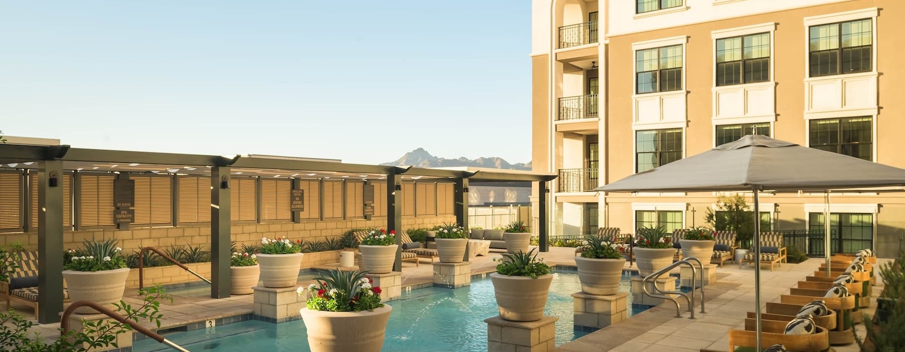 pool area with reclining seats and landscaping