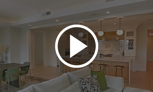 a play button on top of an image of a kitchen
