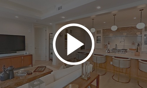 a play button on top of an image of a kitchen