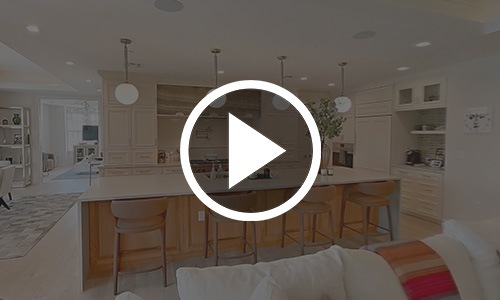 a play button on top of an image of a kitchen