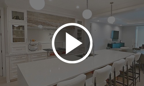 a play button on top of an image of a kitchen